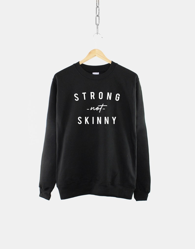 May include: Black sweatshirt with white text that reads "STRONG -not- SKINNY".