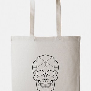 May include: A white canvas tote bag with a black geometric skull design.