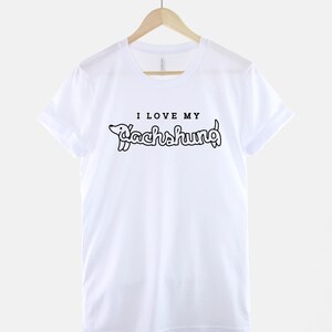 May include: White t-shirt with black text that reads "I love my Dachshund" with a cartoon dachshund illustration.