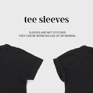 May include: Two black t-shirts with short sleeves. The sleeves on the right shirt are rolled up. The text "tee sleeves" and "Sleeves are not stitched. They can be worn rolled up or normal" is printed above the shirts.