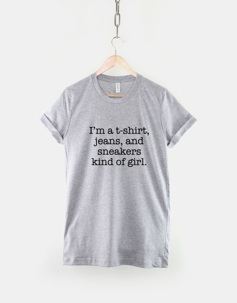 May include: Gray t-shirt with the text "I'm a t-shirt, jeans, and sneakers kind of girl."