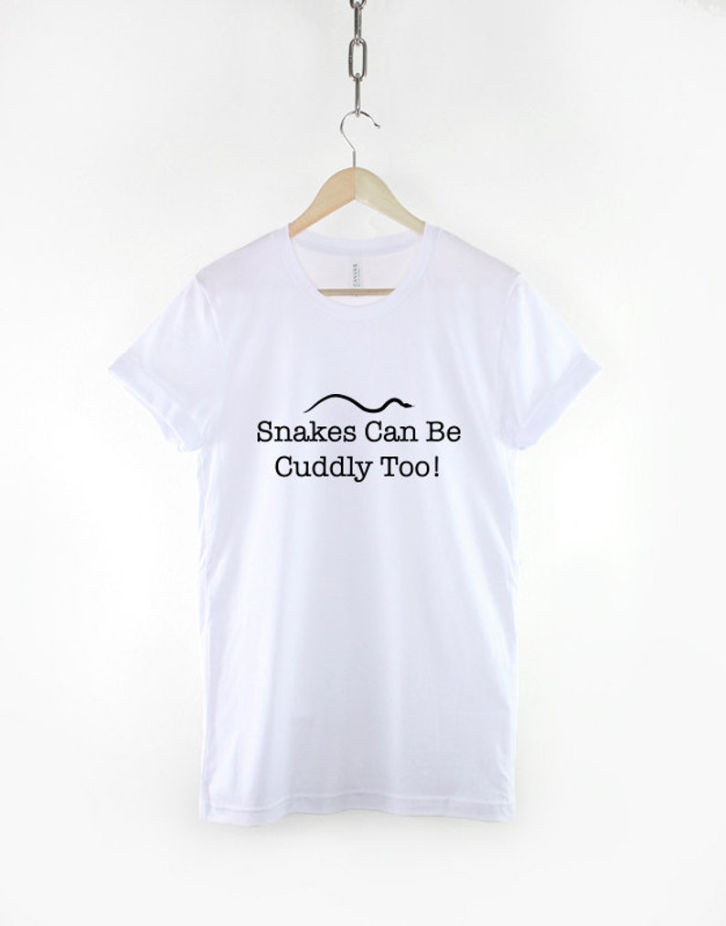 May include: White t-shirt with a black snake graphic and the text "Snakes Can Be Cuddly Too!"