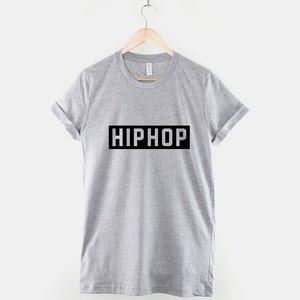 May include: A gray t-shirt with the word "HIPHOP" printed in a black rectangle on the front.