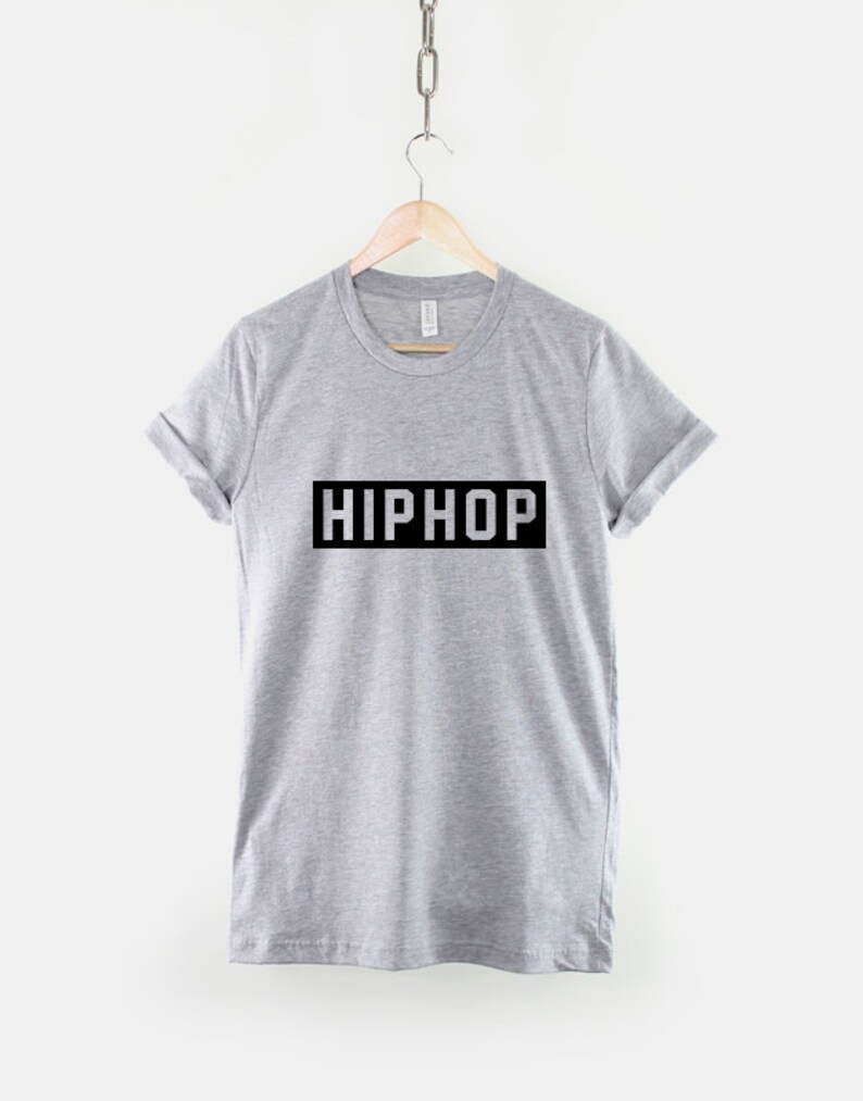 May include: A gray t-shirt with the word "HIPHOP" printed in a black rectangle on the front.