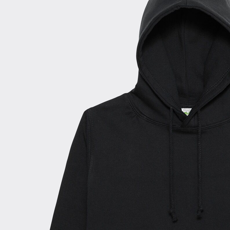 May include: Black hooded sweatshirt with a drawstring. The hoodie has a small green label with text.