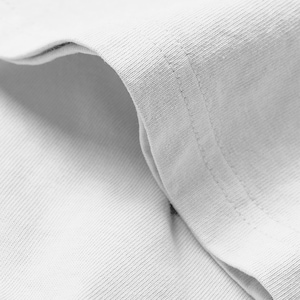 May include: A close-up view of a light gray cotton fabric garment featuring a visible double-stitched seam along the curved edge. The material displays a fine, uniform knit texture with soft folds creating subtle shadows across the surface.
