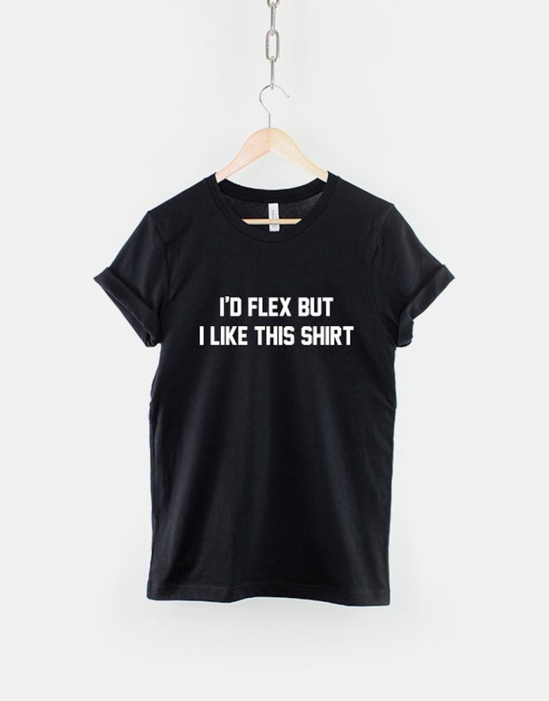 May include: Black t-shirt with white text that reads "I'd flex but I like this shirt."