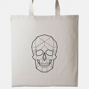 May include: A white canvas tote bag with a geometric skull design printed in black.