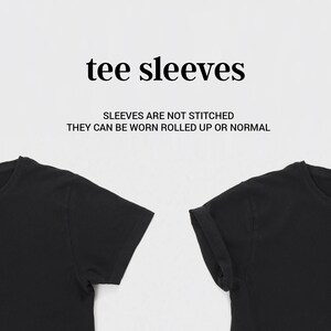 May include: Two black t-shirts with short sleeves. The sleeves on the right shirt are rolled up. The text "tee sleeves" and "Sleeves are not stitched. They can be worn rolled up or normal" is displayed above the shirts.