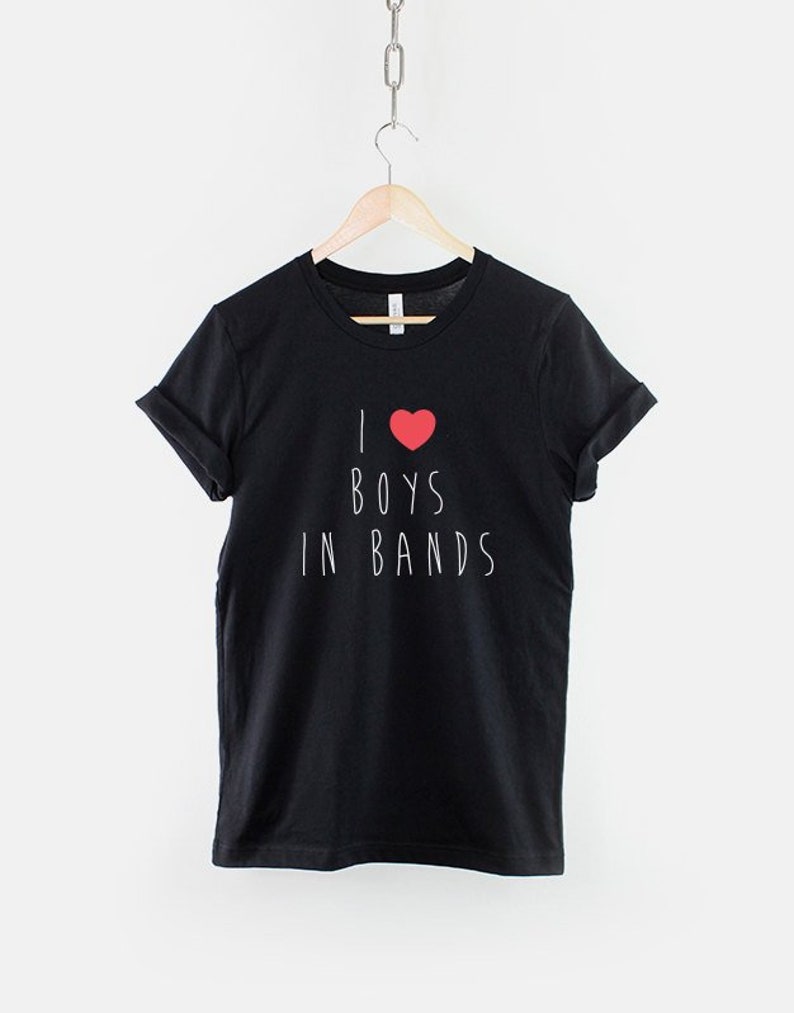 May include: Black t-shirt with white text that reads "I &hearts; BOYS IN BANDS".