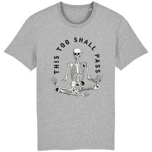 May include: A gray t-shirt with a black and white skeleton sitting in a yoga pose. The skeleton is surrounded by a circle with the text "This too shall pass".