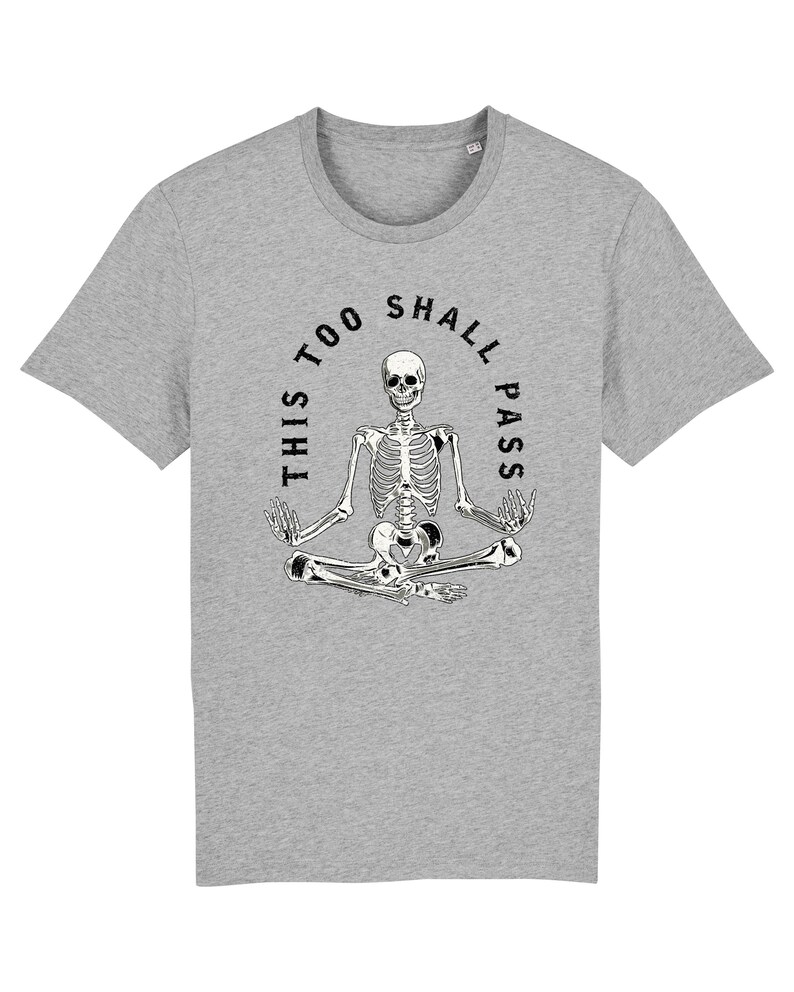 May include: A gray t-shirt with a black and white skeleton sitting in a yoga pose. The skeleton is surrounded by a circle with the text "This too shall pass".