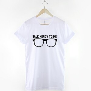 May include: White t-shirt with black text that reads "Talk Nerdy To Me." and a pair of black eyeglasses.