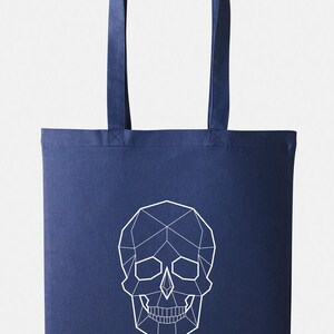 May include: A navy blue tote bag with a white geometric skull design.