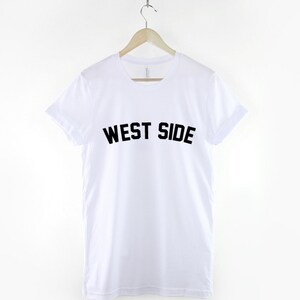 May include: White t-shirt with black text that reads "WEST SIDE" on the front.