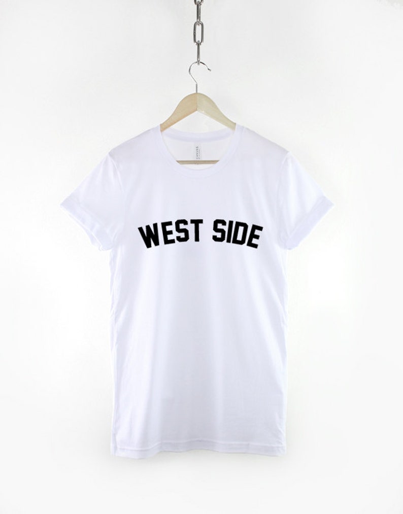 May include: White t-shirt with black text that reads "WEST SIDE" on the front.