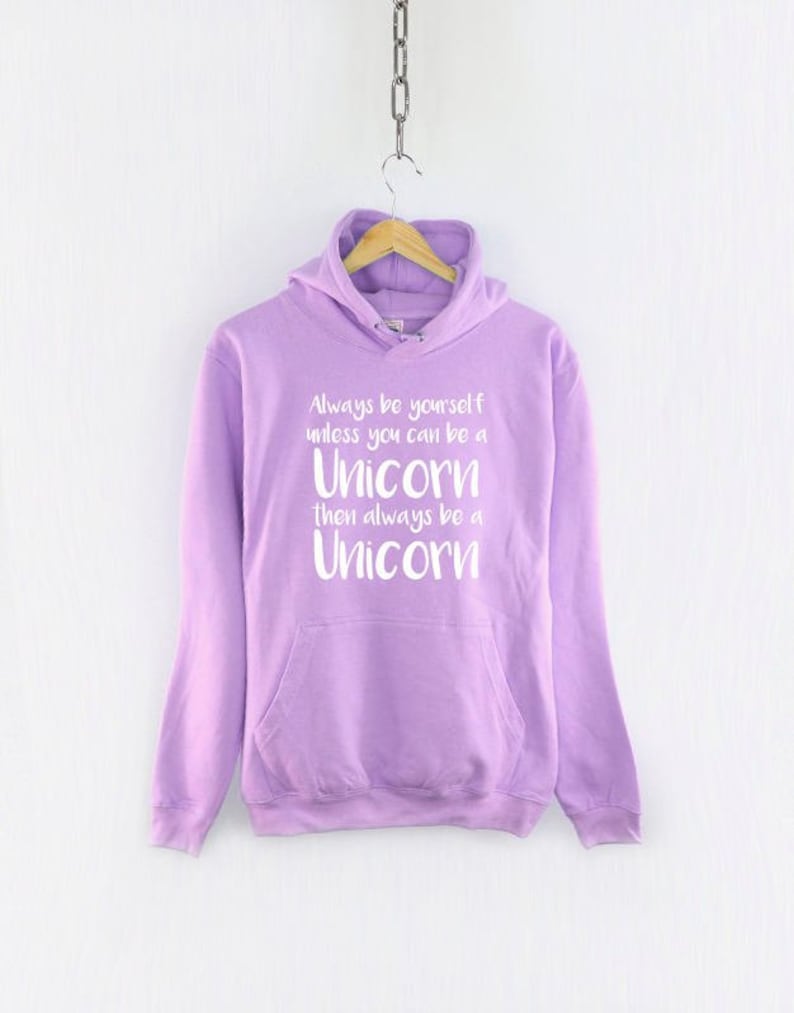 May include: A lavender hoodie with a white graphic that reads "Always be yourself unless you can be a Unicorn then always be a Unicorn."