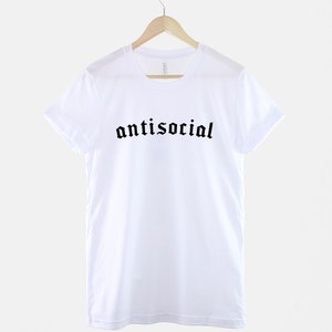 May include: White t-shirt with black gothic lettering that reads "antisocial".