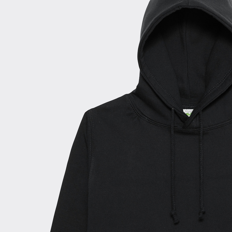 May include: A black hooded sweatshirt with a drawstring. The hoodie has a green label with the word "organic" on it.