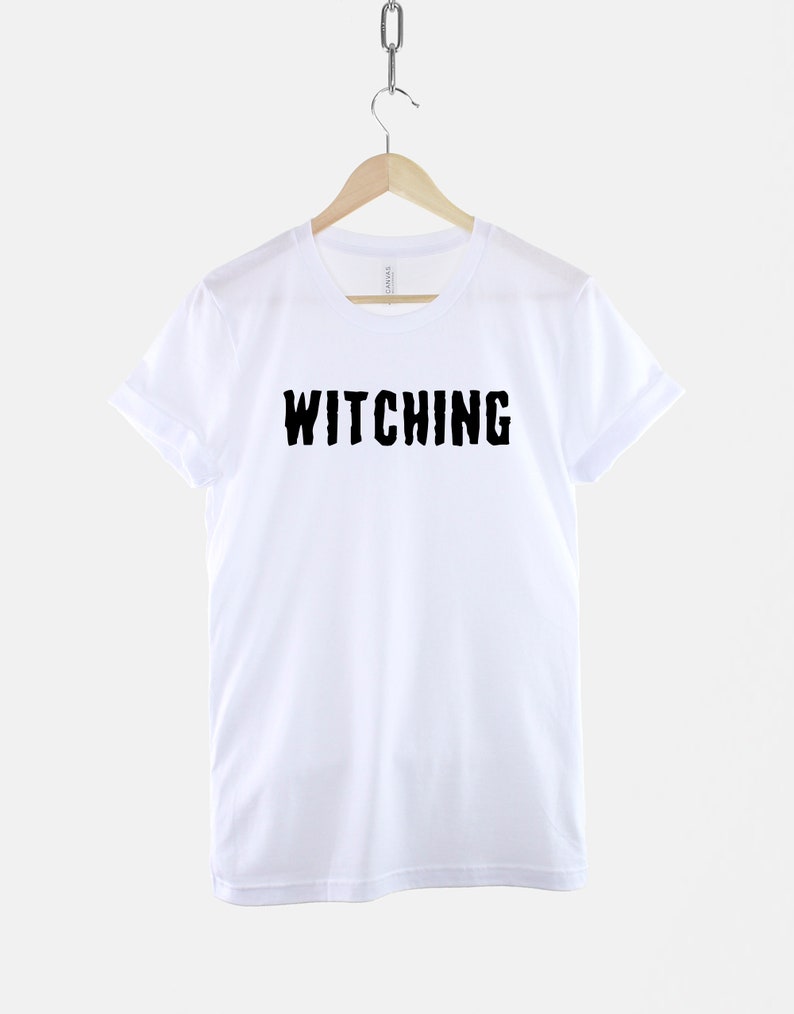 May include: White t-shirt with black text that reads "Witching" in a distressed font.