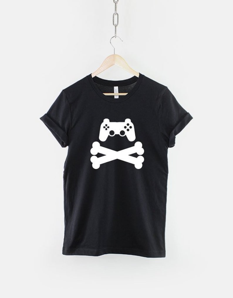 May include: Black t-shirt with a white graphic of a video game controller and crossed bones.