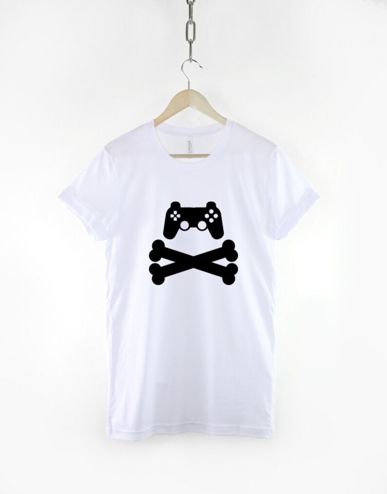 May include: White t-shirt with a black graphic of a video game controller and crossed bones.