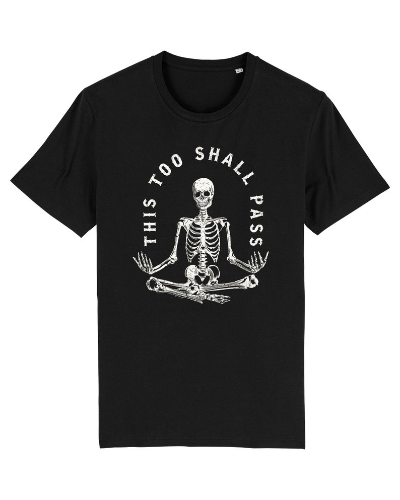 May include: Black t-shirt with a white skeleton sitting in a yoga pose. The skeleton is surrounded by a circle with the text "This too shall pass".