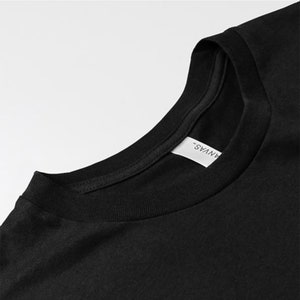 May include: Black t-shirt with a white "ANVYAS" label sewn into the neckline.