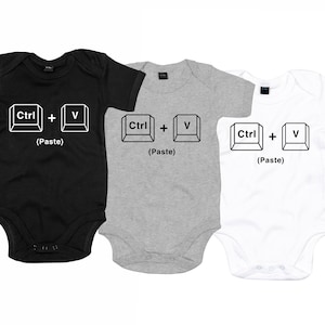 May include: Three baby onesies in black, gray, and white with a graphic of computer keys that say "Ctrl + V (Paste)".