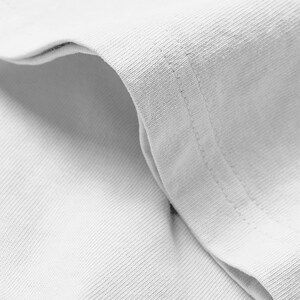 A close-up view of a white fabric, possibly a shirt or towel, with a slight crease visible.