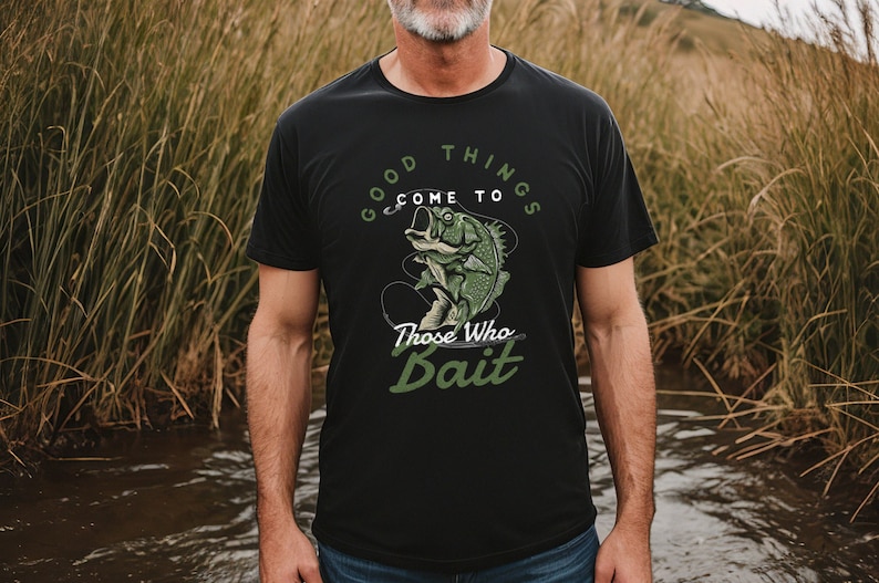 May include: A black t-shirt with a green and white graphic of a fish on a hook. The text on the shirt reads "Good Things Come To Those Who Bait."