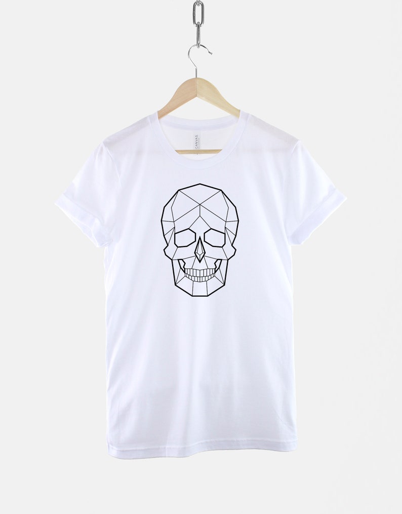 May include: White t-shirt with a black geometric skull design.