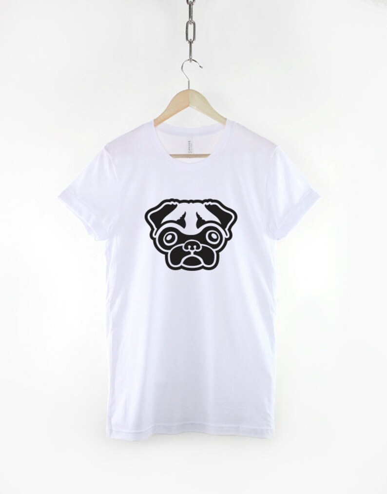 May include: White t-shirt with a black and white pug illustration on the front.