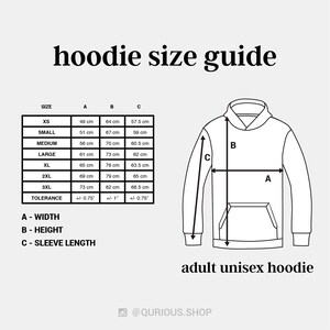 May include: A size chart for adult unisex hoodies with measurements in centimeters for width, height, and sleeve length. The chart includes sizes XS to 3XL and a tolerance of +/- 0.75 inches.