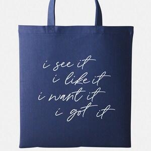 May include: A navy blue tote bag with white text that reads "i see it i like it i want it i got it".