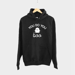 May include: Black hooded sweatshirt with a white ghost graphic and the text "You do you boo".