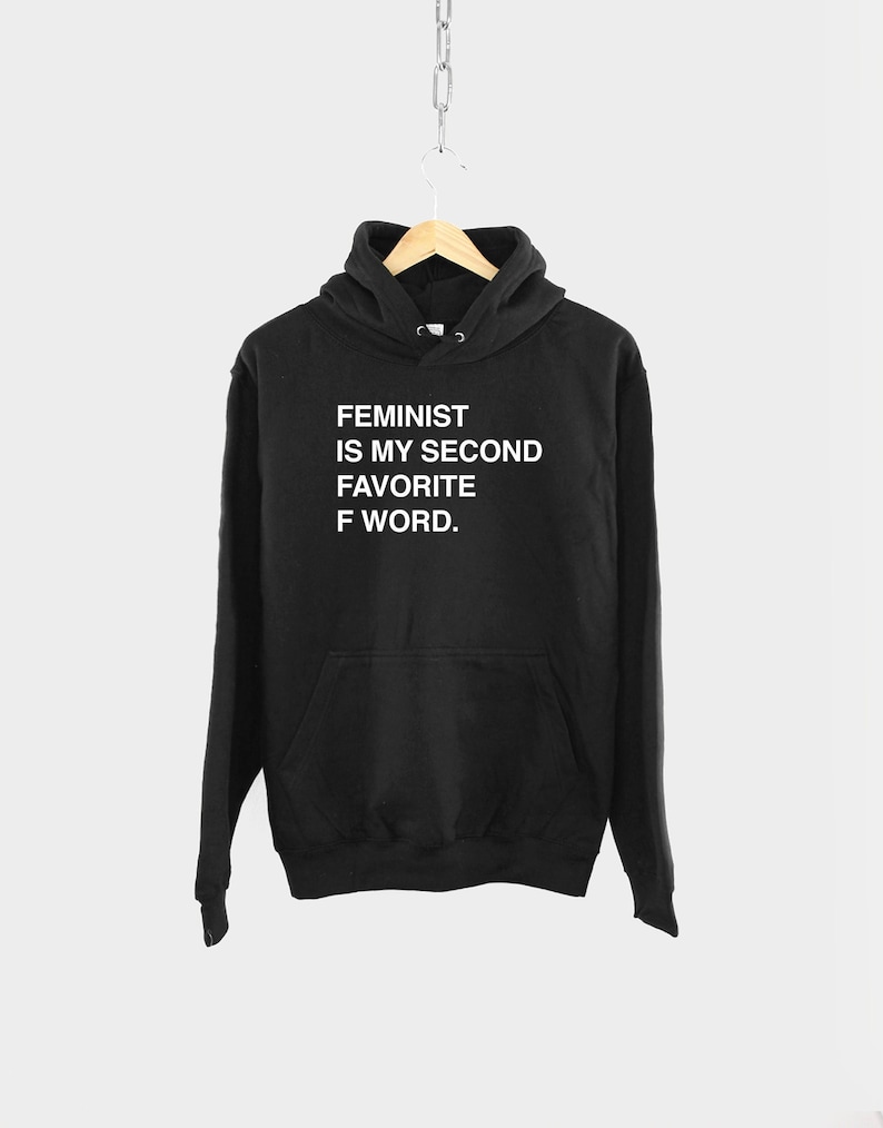 May include: Black hooded sweatshirt with the text "FEMINIST IS MY SECOND FAVORITE F WORD." printed in white.