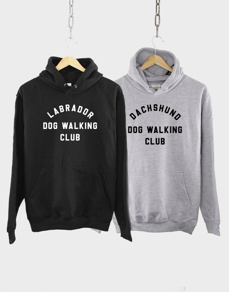 May include: Two hooded sweatshirts, one black and one gray, with the text "Labrador Dog Walking Club" and "Dachshund Dog Walking Club" printed on the front.