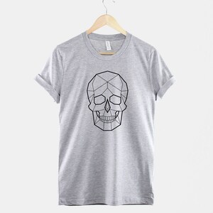 May include: A heather grey t-shirt with a geometric skull design in black.