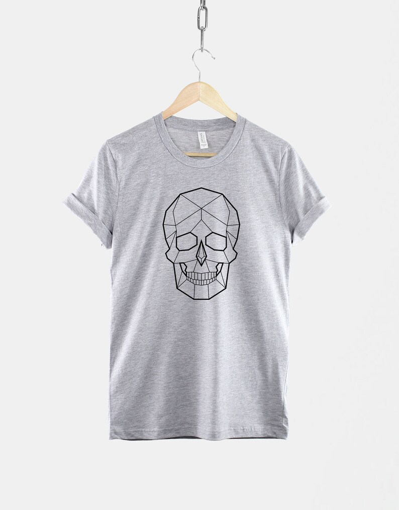 May include: A heather grey t-shirt with a geometric skull design in black.