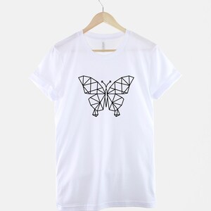 May include: White t-shirt with a black geometric butterfly design.