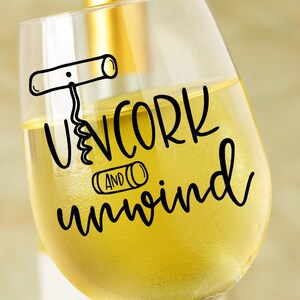 May include: A white wine glass with the text "Uncork and unwind" in black lettering. The text includes a drawing of a corkscrew.