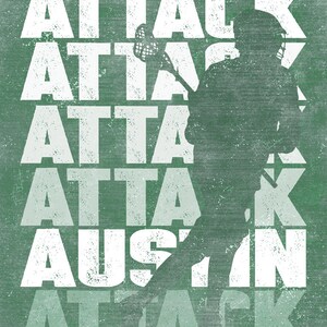May include: A green and white graphic design featuring a silhouette of a lacrosse player with a lacrosse stick. The text "ATTACK" is repeated multiple times in a faded effect.