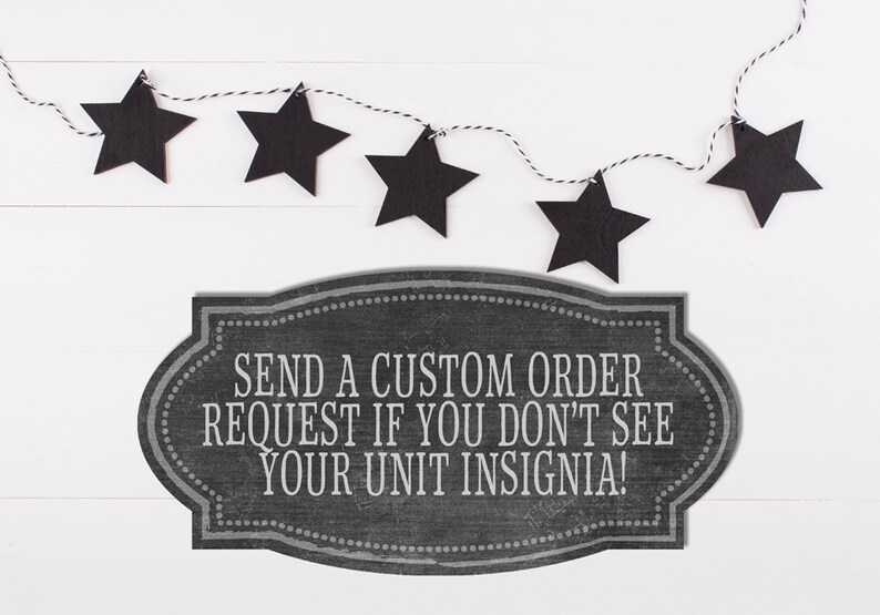 May include: Black chalkboard sign with white text that reads "Send a custom order request if you don't see your unit insignia!"  A string of black stars hangs above the sign.