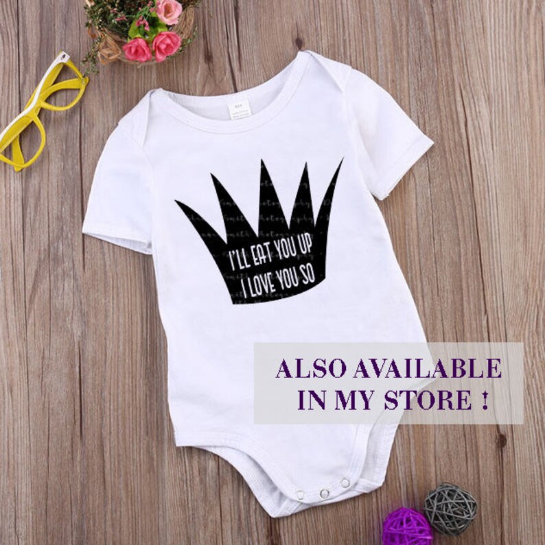K&ouml;nnte beinhalten: Wei&szlig;er Baby-Body mit schwarzem Kronen-Motiv und dem Text "I'LL EAT YOU UP I LOVE YOU SO." Der Body hat kurze &Auml;rmel und Druckkn&ouml;pfe am unteren Ende. Der Text "ALSO AVAILABLE IN MY STORE !" ist ebenfalls sichtbar.