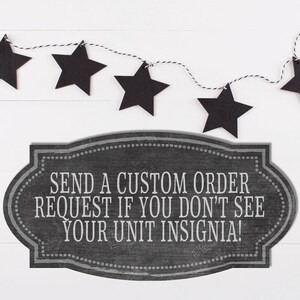 May include: Black chalkboard sign with white text that reads "Send a custom order request if you don't see your unit insignia!"  A string of black stars hangs above the sign.