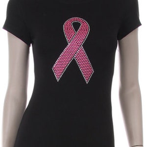 May include: Black t-shirt with a pink rhinestone ribbon design.