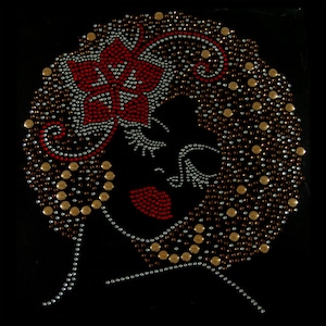 May include: A black and white rhinestone design of a woman's face with a red flower in her hair. The design is made up of small, round rhinestones.