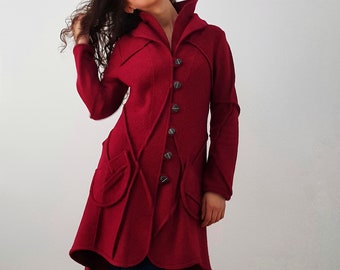 May include: A red wool coat with a high collar and a unique design. The coat has a long, flowing hemline and a fitted waist. The coat is buttoned up the front with silver buttons.