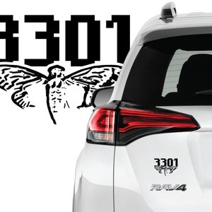 May include: Black and white sticker of a moth with the number 3301 on a white car.